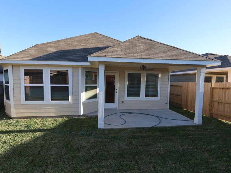 Exterior details and patio area of a home in Pinewood at Grand Texas, New Caney (Image 18).