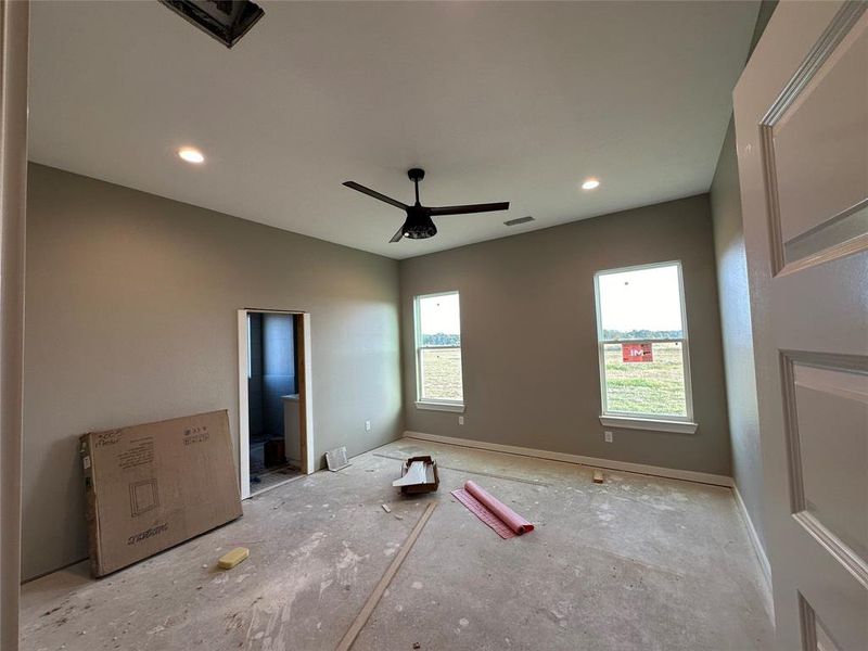 Unfurnished bedroom featuring ensuite bath and ceiling fan