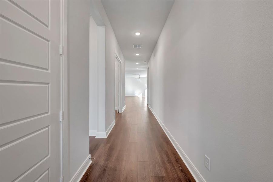 Hallway with recessed lighting and dark wood-type flooring