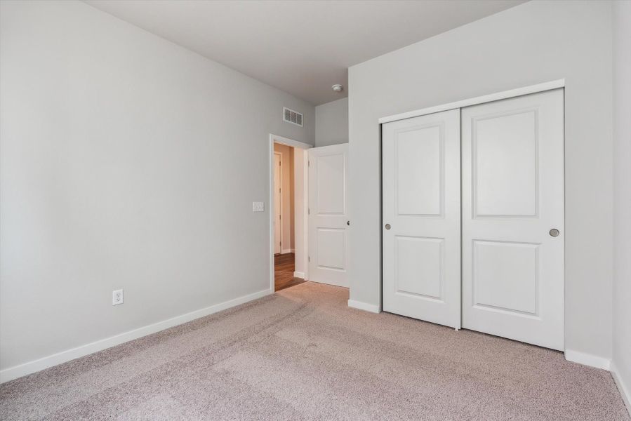 A hallway with white doors.