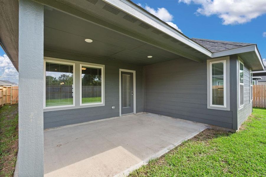 The Charming Covered Patio is a welcoming outdoor space, ideal for al fresco dining, entertaining guests, or simply unwinding in the fresh air.