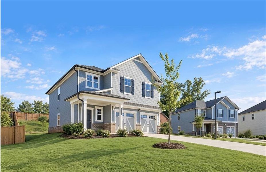 Front exterior of a new home in Millers Pointe, Conyers, GA, highlighting curb appeal (Image 2).