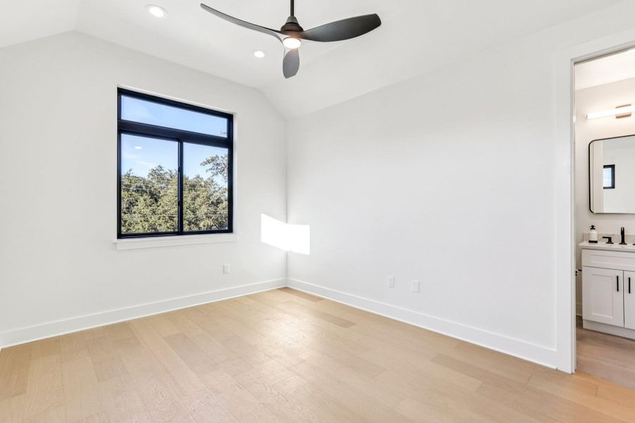 The second level features a spacious guest bedroom that provides essential versatility, making it perfect for a roommate, a secluded home office, or a private suite for visitors