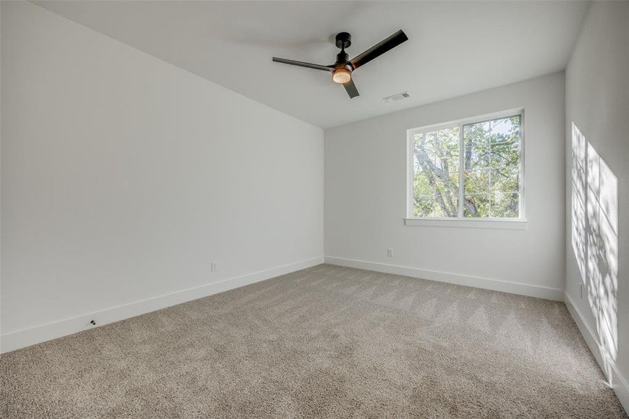 Empty room with carpet floors and ceiling fan