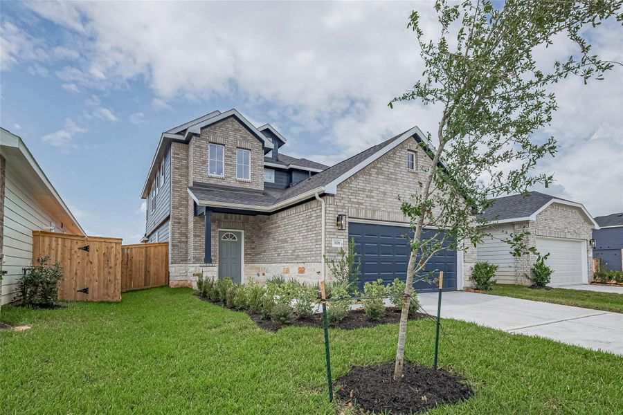 Front exterior of a new home in La Segarra, Brookshire, TX, highlighting curb appeal (Image 2). Front exterior of a new home in La Segarra, Brookshire, TX, highlighting curb appeal (Image 2).