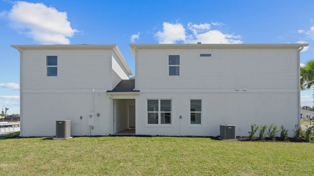 Exterior side view with lanai, 2 car garage and above retreat in a DRB Homes Ambersweet model at the Trinity Place community. Exterior side view with lanai, 2 car garage and above retreat in a DRB Homes Ambersweet model at the Trinity Place community.