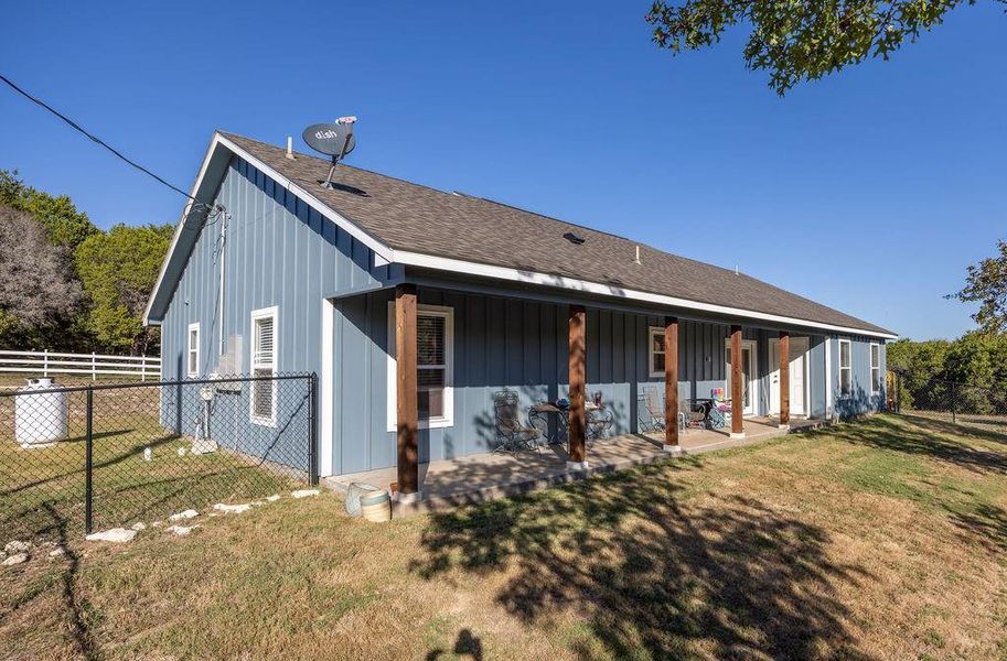 Rear view of property featuring a shingled roof and board and batten siding