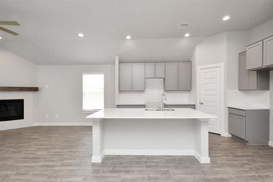 Another view of the kitchen and massive island. Sample photo of completed plan. As built color and selections may vary.