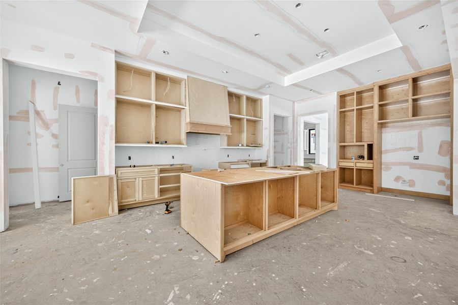 Kitchen will be fitted with Thermador appliances. Primary bedroom is accessed through the entry on the left.