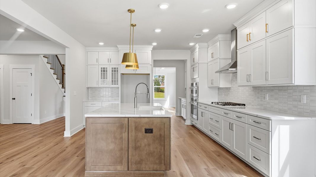 Tasteful kitchen with oversized island and stylish pendant lighting—crafted to high standards near Downtown Greenville