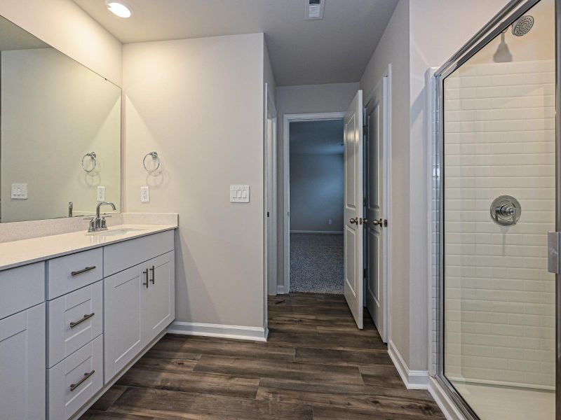 The primary bathroom has dual sinks and plenty of counter space.