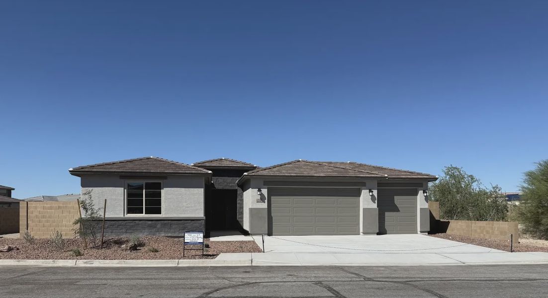Front exterior of a new home in Las Barrancas, Yuma, AZ, highlighting curb appeal (Image 1). Front exterior of a new home in Las Barrancas, Yuma, AZ, highlighting curb appeal (Image 1).