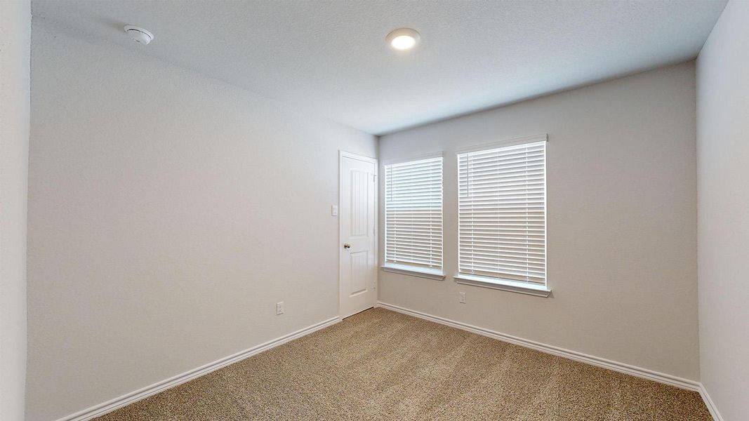 Spare room featuring carpet flooring and a smoke detector Spare room featuring carpet flooring and a smoke detector