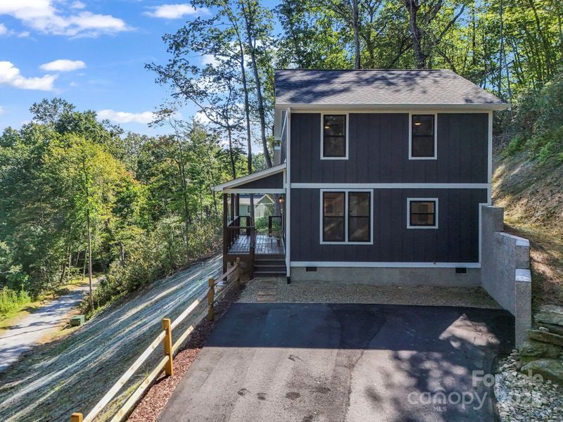View of the right side of the home coming up the driveway