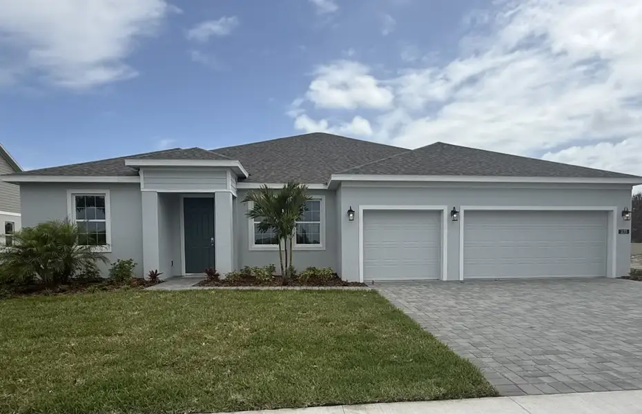 Front exterior of a new home in Country Club Estates, Palm Bay, FL, highlighting curb appeal (Image 1). Front exterior of a new home in Country Club Estates, Palm Bay, FL, highlighting curb appeal (Image 1).