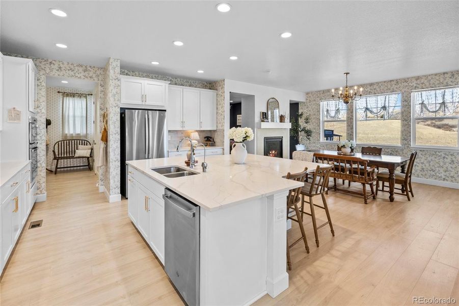 Huge, open kitchen w sunlight streaming through the windows