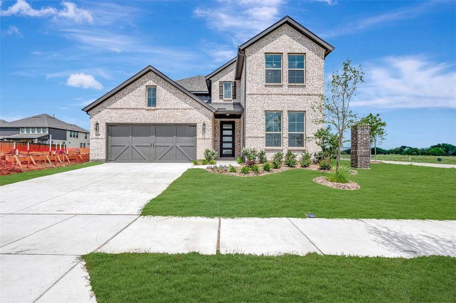 Front exterior of a new home in Lily Creek at Sutton Fields, Aubrey, TX, highlighting curb appeal (Image 1). Front exterior of a new home in Lily Creek at Sutton Fields, Aubrey, TX, highlighting curb appeal (Image 1).