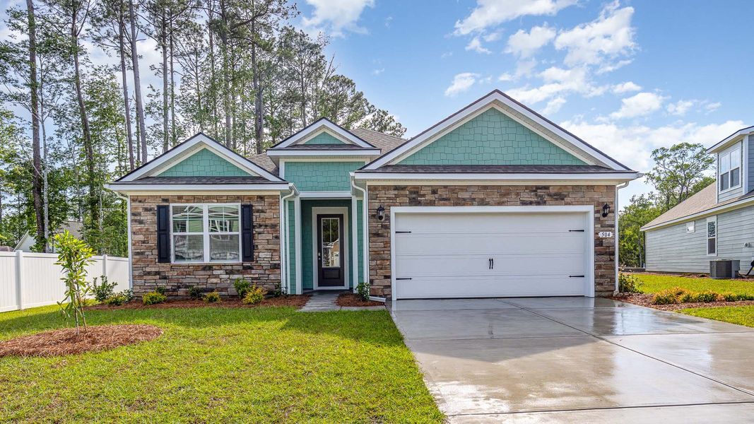 Front exterior of a new home in Heron Pointe, Myrtle Beach, SC, highlighting curb appeal (Image 1).