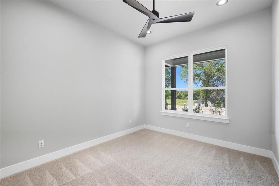 Empty room with light colored carpet, ceiling fan, and recessed lighting Empty room with light colored carpet, ceiling fan, and recessed lighting