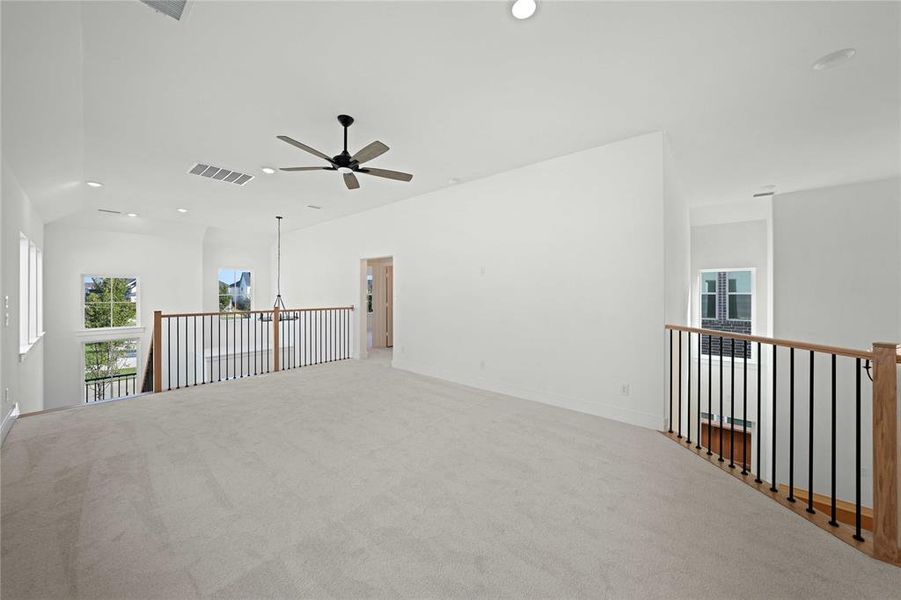 Carpeted empty room with plenty of natural light, recessed lighting, and ceiling fan Carpeted empty room with plenty of natural light, recessed lighting, and ceiling fan