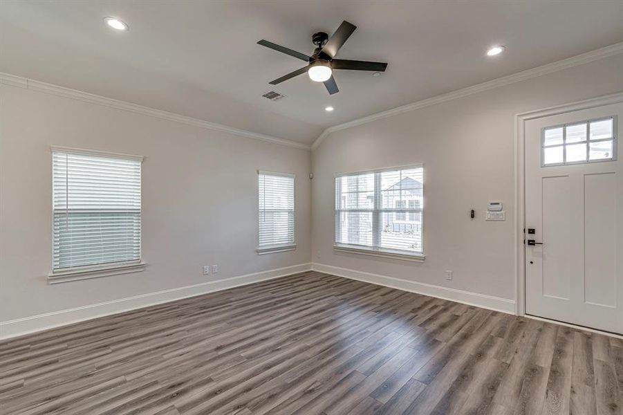 Foyer with ornamental molding, wood finished floors, recessed lighting, and a ceiling fan Foyer with ornamental molding, wood finished floors, recessed lighting, and a ceiling fan
