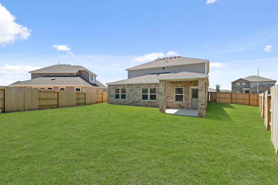 Front exterior of a new home in Sunterra, Katy, TX, highlighting curb appeal (Image 1).