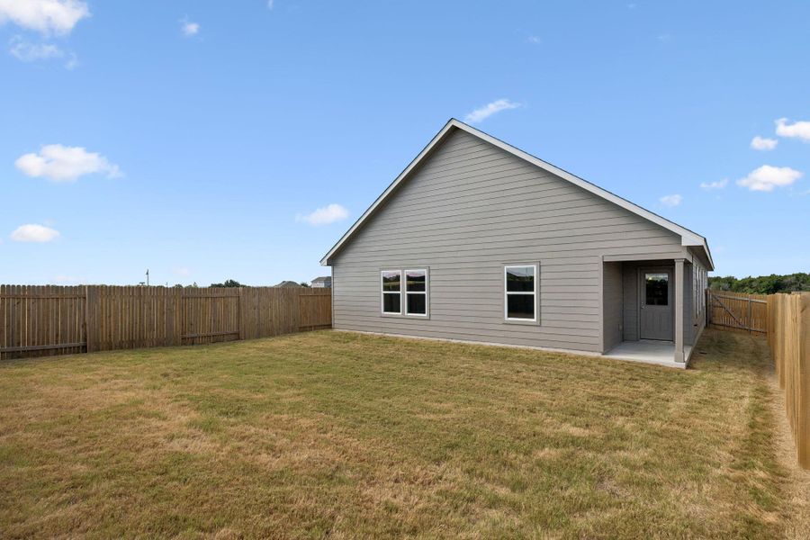 Fully enclosed wood-fenced backyard.