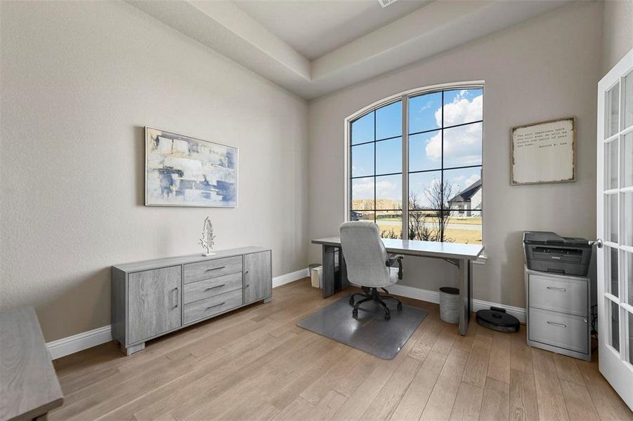 Office area featuring light wood-type flooring and french doors