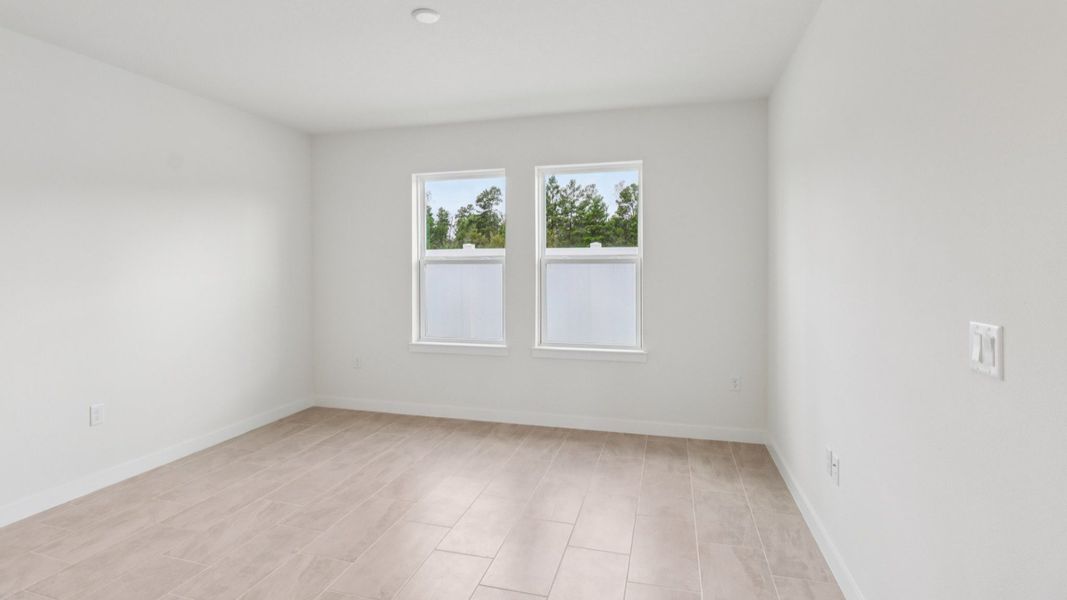 Living Room in the Monterey End Townhome by DRB Homes - Cyrene at Harmony in St Cloud FL