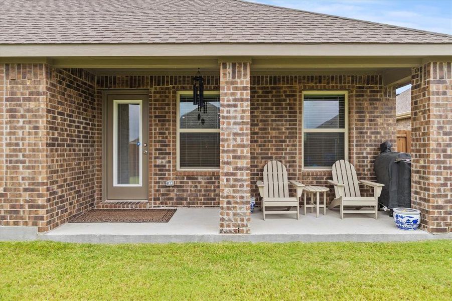 Covered patio overlooking fenced backyard Covered patio overlooking fenced backyard