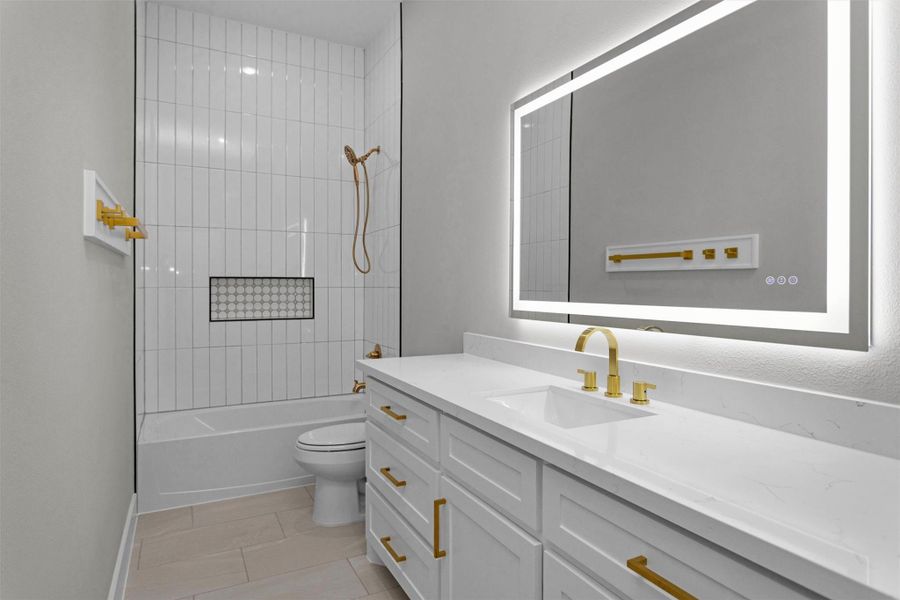 Full bathroom with tub/shower combo and backlit mirror. Full bathroom with tub/shower combo and backlit mirror.