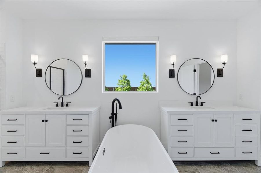 Dual vanities featuring white shaker-style cabinetry, matte black hardware, and round mirrors Dual vanities featuring white shaker-style cabinetry, matte black hardware, and round mirrors