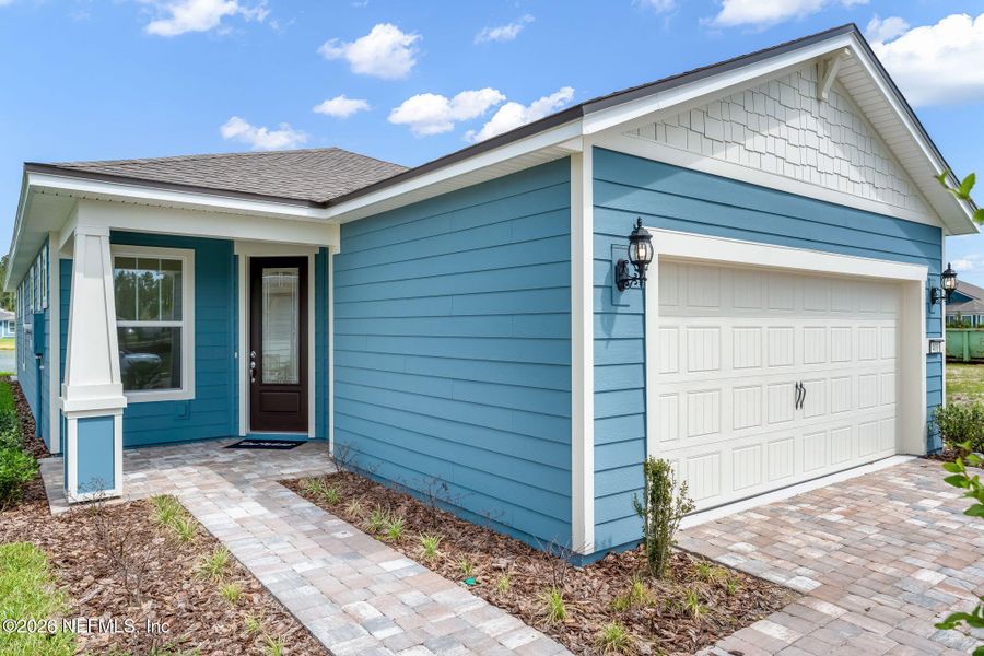 Exterior details and patio area of a home in Del Webb Wildlight, Wildlight (Image 23).