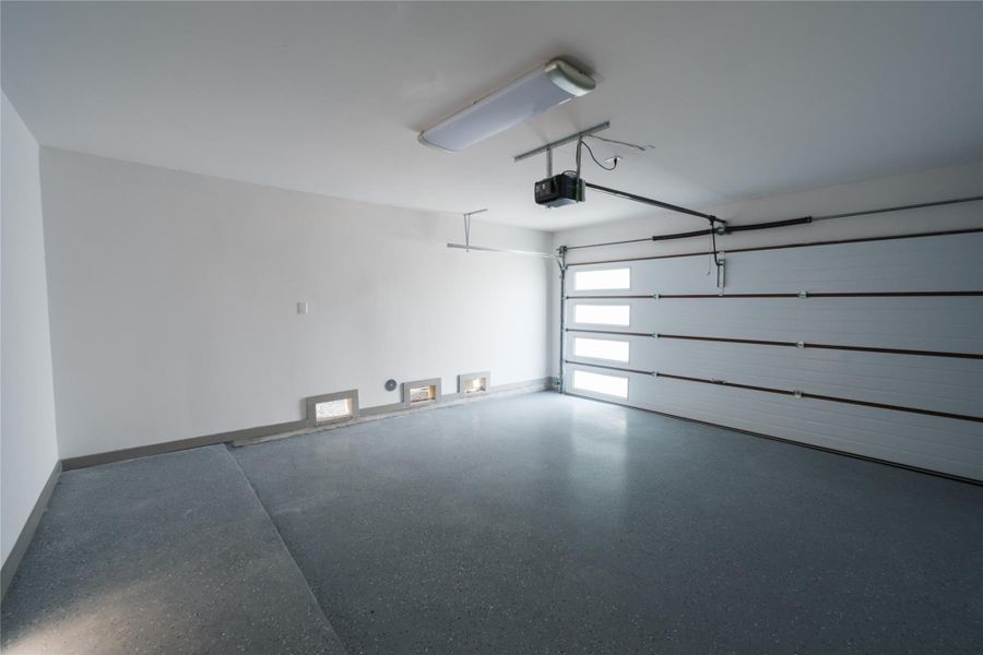 Representative Garage View (Design selections and colors may vary): The two car garage includes insulated doors for temperature control and durable Epoxy flooring for a clean, polished and low-maintenance finish.