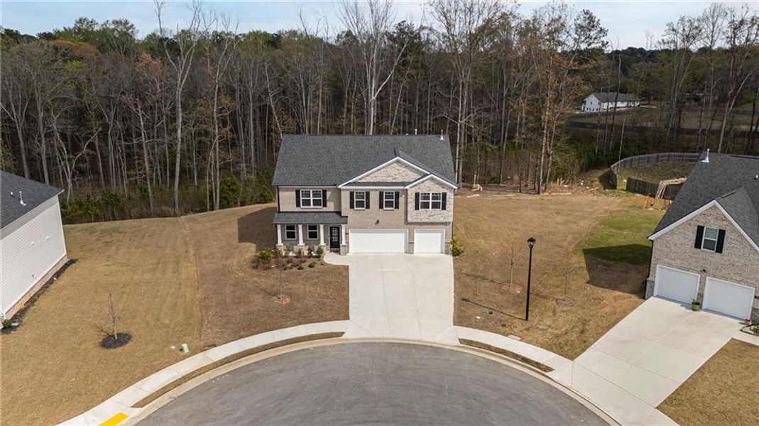 Front exterior of a new home in Independence, Loganville, GA, highlighting curb appeal (Image 21).