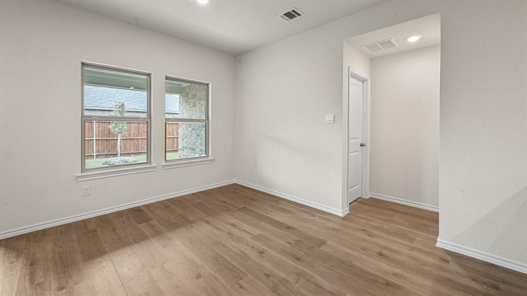 Spare room with light wood finished floors and recessed lighting