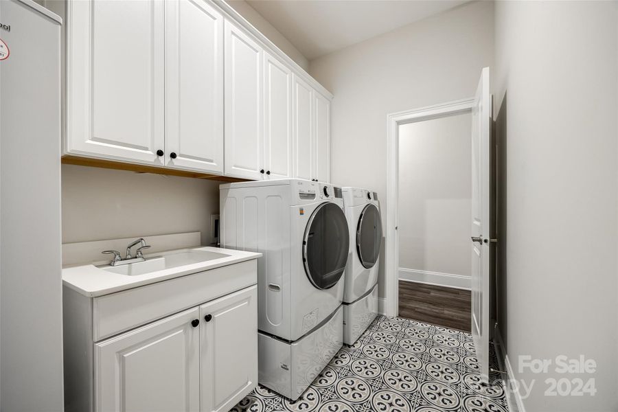 This expansive laundry room is conveniently located adjacent to the primary closet.  Washer and dryer are included!