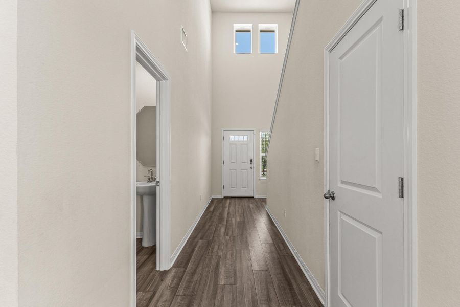 Entryway with wood finished floors and a high ceiling Entryway with wood finished floors and a high ceiling