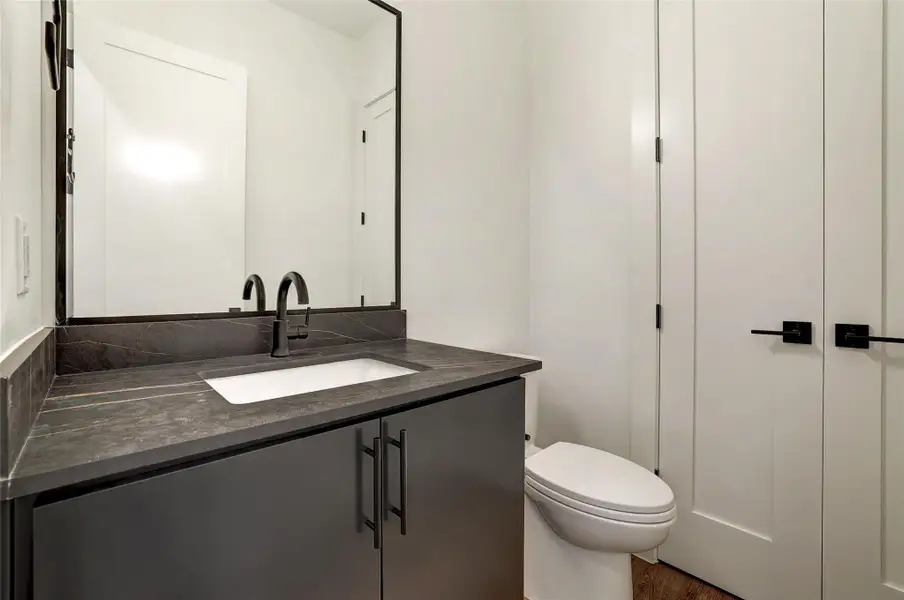 Half bath featuring vanity and toilet