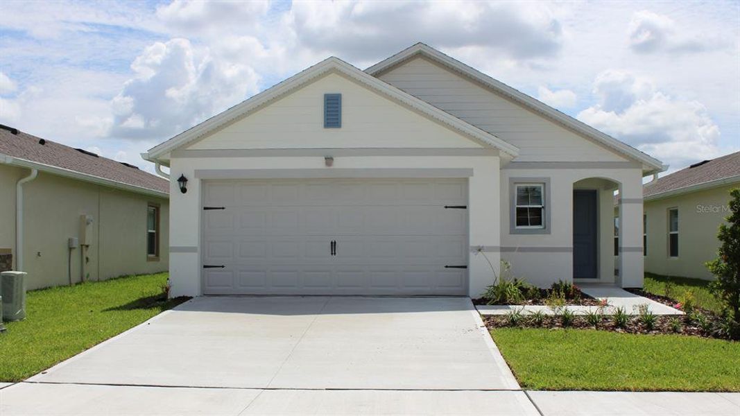 Front exterior of a new home in Fox Branch, Lakeland, FL, highlighting curb appeal (Image 1). Front exterior of a new home in Fox Branch, Lakeland, FL, highlighting curb appeal (Image 1).