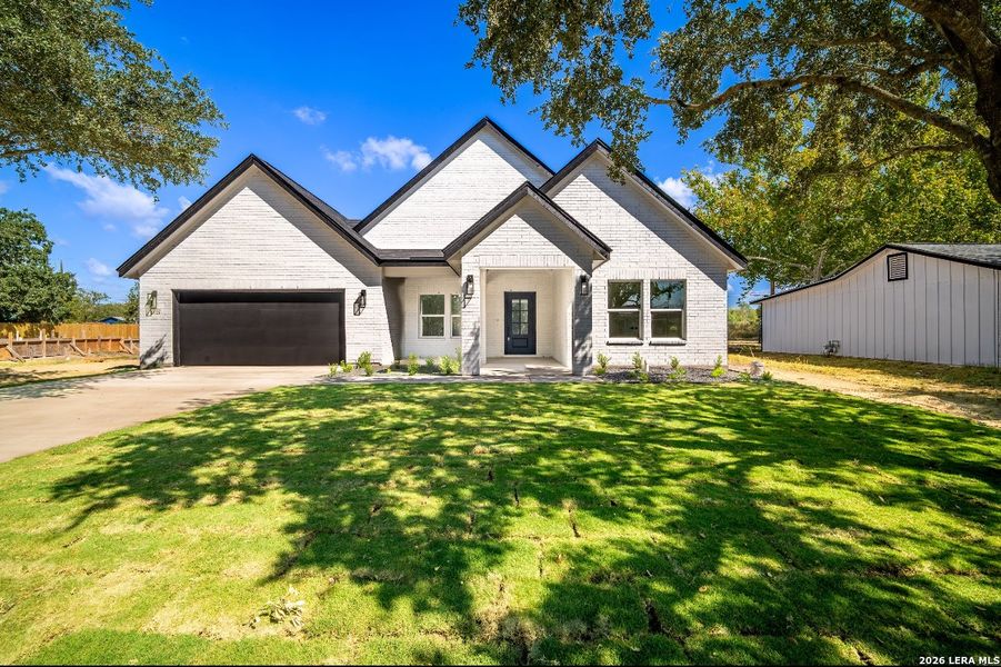 Front exterior of a new home in , La Vernia, TX, highlighting curb appeal (Image 17).