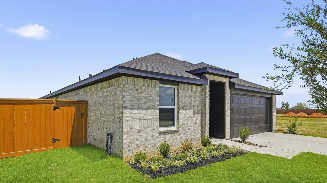 Front exterior of a new home in Sunterra, Katy, TX, highlighting curb appeal (Image 16).