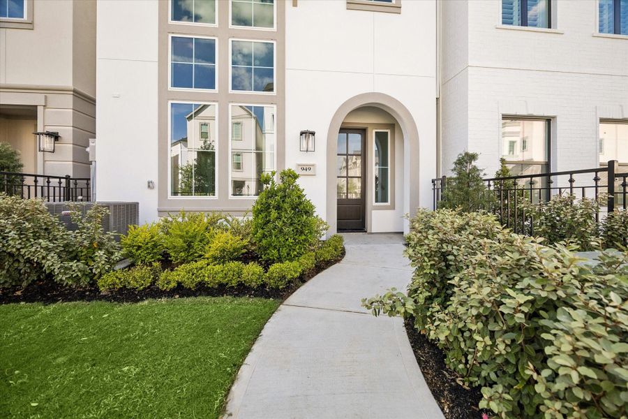 A beautiful view of your new home as you step through the gate and onto the path to your front door.