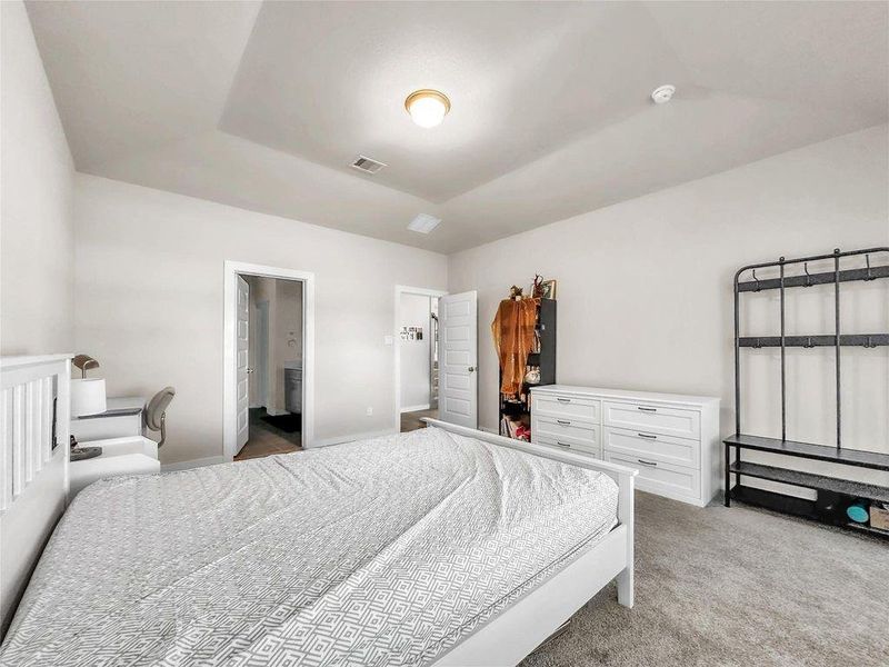 Private first-floor primary suite featuring generous space, large windows for natural light, and a relaxing atmosphere.