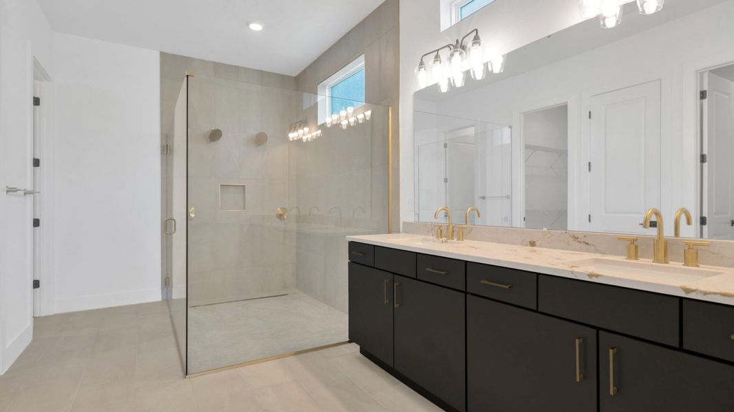 The Primary Bathroom of a DRB Homes Grand Hawk which is offered as a home plan at Serengeti in Spring Hill, FL.