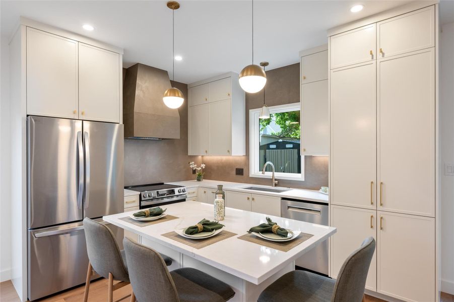 Culinary aspirations come alive in this well-appointed kitchen, featuring a central island and contemporary fixtures. Culinary aspirations come alive in this well-appointed kitchen, featuring a central island and contemporary fixtures.