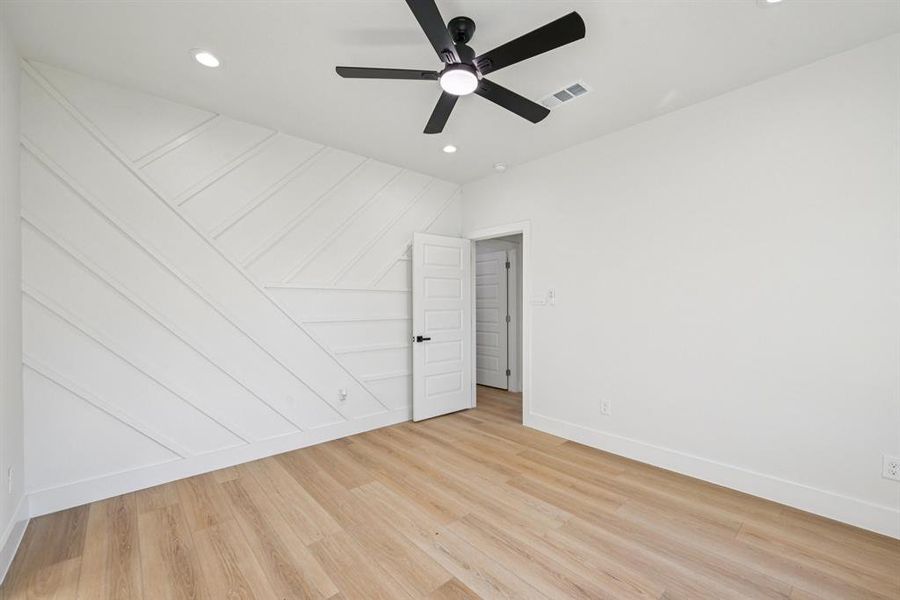Empty room with light wood-type flooring, recessed lighting, and a ceiling fan