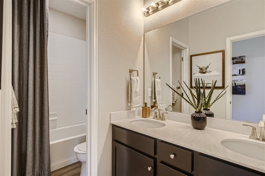 A bathroom with a sink and a toilet. A bathroom with a sink and a toilet.
