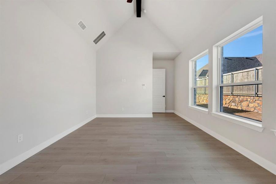 Empty room featuring baseboards and light wood-type flooring