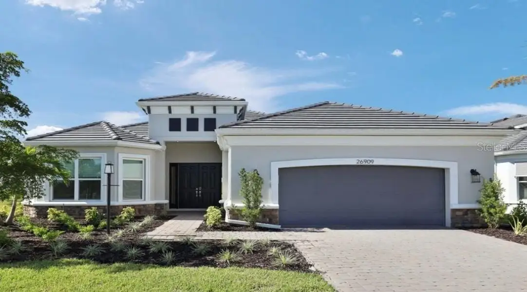 Front exterior of a new home in Esplanade at Starling, Punta Gorda, FL, highlighting curb appeal (Image 1). Front exterior of a new home in Esplanade at Starling, Punta Gorda, FL, highlighting curb appeal (Image 1).